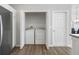 A laundry closet with white washer and dryer units located next to the kitchen area at 2142 Weber Ct, The Villages, FL 32163