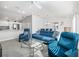 Bright living room flows into the dining area and features modern seating and a glass table at 2142 Weber Ct, The Villages, FL 32163