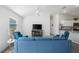 Cozy living room with vaulted ceiling, ceiling fan, ample seating, and seamless flow into the dining area and kitchen at 2142 Weber Ct, The Villages, FL 32163