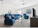 Open living room features modern seating, glass table, and flows into the dining area at 2142 Weber Ct, The Villages, FL 32163