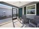 Relax on this screened-in porch with fan, providing outdoor comfort and a view of the well kept yard at 2142 Weber Ct, The Villages, FL 32163