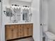 Nicely renovated bathroom showcasing double sinks, modern fixtures, and wood accents at 2235 Harbor Town Ln, Lakeland, FL 33810