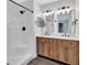 Bright bathroom featuring double sinks, modern fixtures, a shower, and a decorative vanity at 2235 Harbor Town Ln, Lakeland, FL 33810