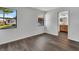 Light-filled bedroom featuring wood floors, a view of the yard, and an entrance to the bathroom at 2235 Harbor Town Ln, Lakeland, FL 33810