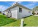 Exterior angle of home with green grass and white vinyl siding at 2235 Harbor Town Ln, Lakeland, FL 33810