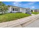 Charming home exterior with well-manicured lawn and golf cart parked in driveway at 2235 Harbor Town Ln, Lakeland, FL 33810