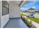 Covered front porch featuring neutral flooring and manicured landscaping at 2235 Harbor Town Ln, Lakeland, FL 33810