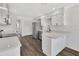 Open kitchen with new stainless steel appliances, white cabinetry, and spacious quartz counters at 2235 Harbor Town Ln, Lakeland, FL 33810