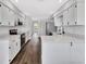 Fully renovated kitchen boasting white cabinets, stainless steel appliances, and breakfast bar at 2235 Harbor Town Ln, Lakeland, FL 33810
