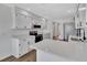 Modern kitchen featuring white cabinets, stainless steel appliances, and quartz countertops with a breakfast bar at 2235 Harbor Town Ln, Lakeland, FL 33810