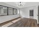 Bright living room featuring wood floors, large windows, and modern lighting fixture at 2235 Harbor Town Ln, Lakeland, FL 33810