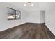 Spacious living area featuring dark wood flooring and a modern light fixture at 2235 Harbor Town Ln, Lakeland, FL 33810