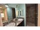 Bathroom featuring double sinks, granite vanity, and a large tiled shower at 2441 Nellie Rd, The Villages, FL 32163