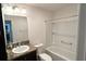 Bathroom with a granite countertop and a white sink next to the toilet and shower at 2441 Nellie Rd, The Villages, FL 32163