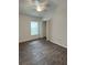 Bedroom featuring a window, ceiling fan and wood-look floors at 2441 Nellie Rd, The Villages, FL 32163