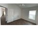 Bedroom features a window, wood-look floors, and ceiling fan at 2441 Nellie Rd, The Villages, FL 32163