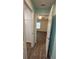 Open doorway into bedroom featuring tray ceiling, a fan, and wood-look floors at 2441 Nellie Rd, The Villages, FL 32163