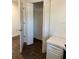 Walk-in closet with an open door, shelving, and wood flooring at 2441 Nellie Rd, The Villages, FL 32163