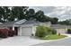 Charming single-story home featuring a well-manicured lawn and an attached garage at 2441 Nellie Rd, The Villages, FL 32163