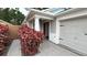 Inviting front entrance showcasing a well-lit porch and a red front door at 2441 Nellie Rd, The Villages, FL 32163