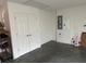 Clean garage interior with white walls, double door closet, and electrical panel at 2441 Nellie Rd, The Villages, FL 32163