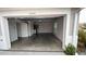 Spacious garage interior featuring an open layout, large double door, and bright lighting at 2441 Nellie Rd, The Villages, FL 32163