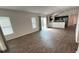 Spacious living area with wood floors, connecting to an open kitchen and dining space at 2441 Nellie Rd, The Villages, FL 32163