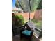 Cozy screened in porch with chair and view of private backyard with garden and greenery at 2441 Nellie Rd, The Villages, FL 32163