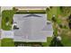 A top-down aerial view shows a home with a modern roof, manicured yard, and decorative driveway at 2738 Morven Park Way, The Villages, FL 32162