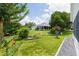 Expansive backyard featuring lush landscaping and a screened-in porch at 2738 Morven Park Way, The Villages, FL 32162