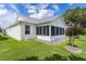 Beautifully landscaped backyard with grass, a patio, and a view of the home at 2738 Morven Park Way, The Villages, FL 32162