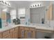 Bright bathroom features dual sinks, vanity, and a large mirror at 2738 Morven Park Way, The Villages, FL 32162