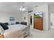 Comfortable bedroom features a ceiling fan, dresser, and calming decor for relaxation at 2738 Morven Park Way, The Villages, FL 32162