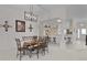 This dining room features a modern chandelier and comfortable seating for a delightful dining experience at 2738 Morven Park Way, The Villages, FL 32162