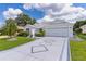 Charming single-story home featuring a decorative driveway, a two-car garage, and mature landscaping at 2738 Morven Park Way, The Villages, FL 32162