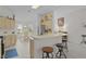 Bright kitchen featuring a breakfast bar with seating, modern appliances, and an adjacent dining area at 2738 Morven Park Way, The Villages, FL 32162