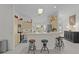 Bright kitchen featuring a breakfast bar with seating, modern appliances, and ample counter space at 2738 Morven Park Way, The Villages, FL 32162