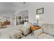 Bright living room with plush seating, ceiling fan, and archway to dining area at 2738 Morven Park Way, The Villages, FL 32162