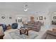 Open living room with a dining area with neutral decor, comfortable furniture, and a view to the dining area at 2738 Morven Park Way, The Villages, FL 32162