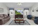 Bright and airy living room with comfortable seating, a modern TV, and elegant décor at 2738 Morven Park Way, The Villages, FL 32162
