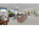 Bright living room with comfortable seating, a large TV, neutral décor, and ample natural light at 2738 Morven Park Way, The Villages, FL 32162
