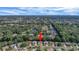 Property aerial view showcasing the home's location near a pond and surrounded by lush greenery in a residential community at 2766 Privada Dr, The Villages, FL 32162