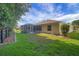 A well-maintained backyard features a screened porch and manicured lawn at 2766 Privada Dr, The Villages, FL 32162