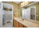 Traditional bathroom featuring floral wallpaper, vanity with sink, and shower with glass doors at 2766 Privada Dr, The Villages, FL 32162