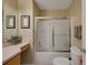 Well-lit bathroom featuring a shower over tub, vanity with a sink, and neutral color scheme at 2766 Privada Dr, The Villages, FL 32162