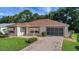 Charming home with a brick driveway and screened garage, complemented by a well-maintained front yard at 2766 Privada Dr, The Villages, FL 32162