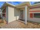 Inviting entrance with a red security door, brick walkway, and well-maintained landscaping at 2766 Privada Dr, The Villages, FL 32162