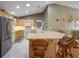 Eat-in kitchen with an island, bar seating, and stainless steel appliances at 2766 Privada Dr, The Villages, FL 32162