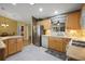 Galley kitchen featuring stainless steel appliances, tiled backsplash, and bright lighting at 2766 Privada Dr, The Villages, FL 32162