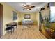 Comfortable living room with wood floors, natural light and a decorative cabinet is perfect for relaxation at 2766 Privada Dr, The Villages, FL 32162